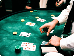 dealer dealing cards at casino table